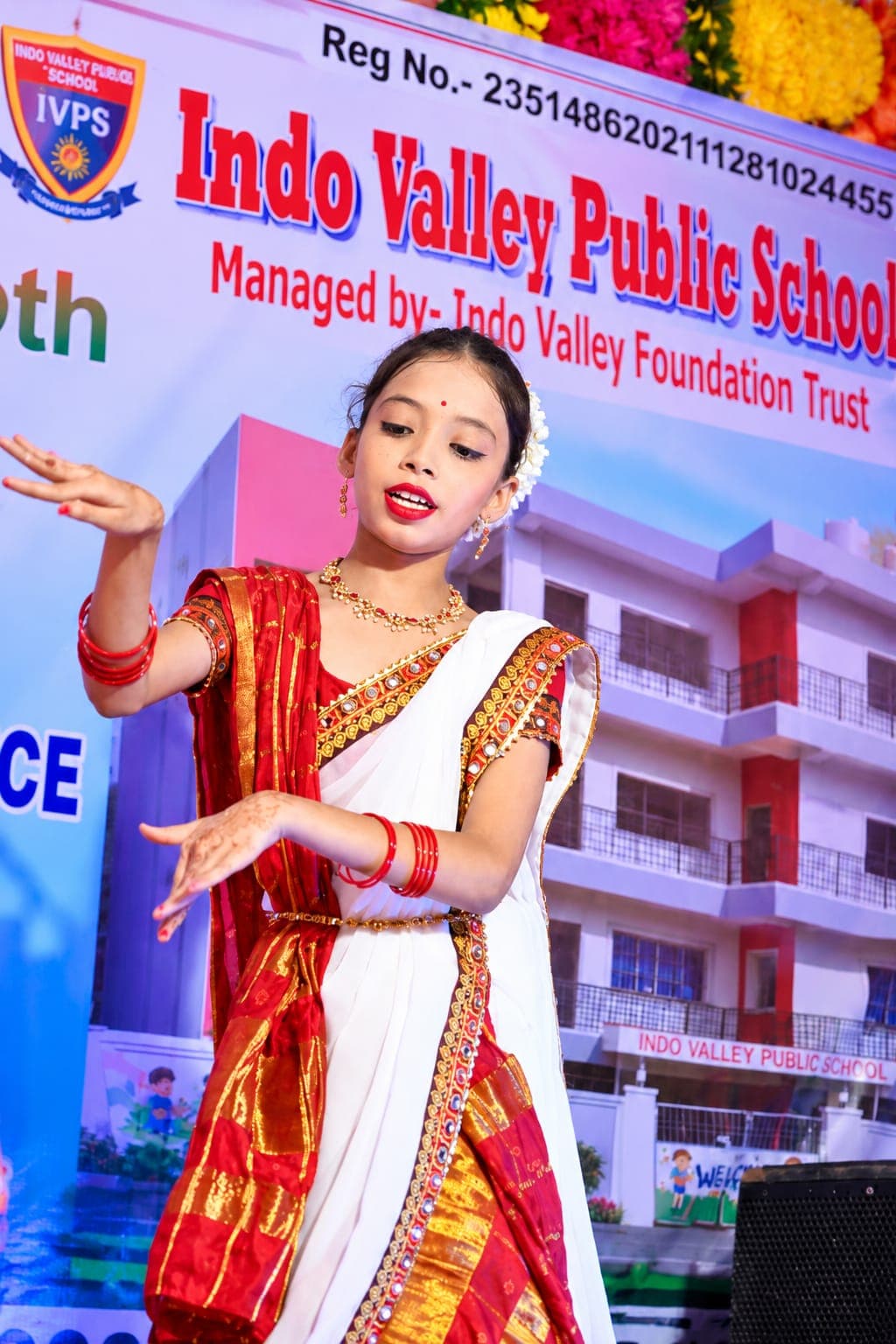 A student performing a classical dance on stage