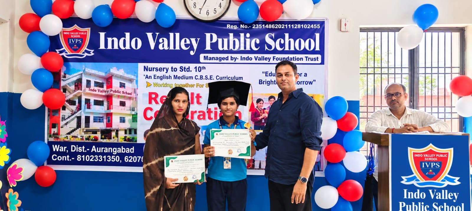 A student receiving a certificate from staff on Result Day